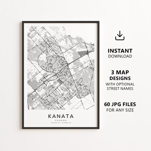 May include: A framed black and white map print of Kanata, Canada, featuring a detailed street grid, the text KANATA CANADA 45.3333 N / 75.8008 W, and accompanying text stating INSTANT DOWNLOAD, 3 MAP DESIGNS WITH OPTIONAL STREET NAMES, 60 JPG FILES FOR ANY SIZE.
