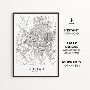 May include: A framed black and white map print of Multan, Pakistan, featuring a detailed street grid layout. The text at the bottom reads MULTAN PAKISTAN 30.1970 N / 71.4687 E. To the right, text reads INSTANT DOWNLOAD 3 MAP DESIGNS WITH OPTIONAL STREET NAMES 60 JPG FILES FOR ANY SIZE.