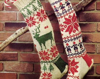 May include: Two knitted Christmas stockings with festive patterns hang against a brick wall. One stocking features a green deer and red floral designs, while the other has red snowflakes and figures. Both are filled with candy canes.
