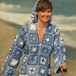 May include: A blue and white crocheted jacket with a hood and zip fastening. The jacket is made of granny squares with a floral design.