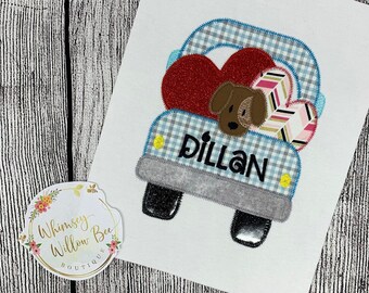 May include: A blue and white checkered truck with a red heart, a brown dog, and a pink and white striped heart. The truck has the name "Dillan" on the side.