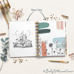 May include: Open planner with floral illustrations and color swatches. The left page features a black and white drawing of an open book with flowers. The right page has painted color swatches and floral line art. Gold pen and paper clips.