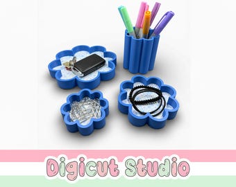 May include: A set of blue, flower-shaped organizers and a pen holder. The organizers hold keys, paper clips, and hair ties. The pen holder contains colorful pens and markers. The text "Digicut Studio" is at the bottom.