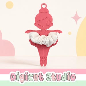 May include: A pink flat ballerina-shaped organiser featuring a loop at the top for hanging. A white fabric scrunchie is wrapped around the waist of the figure. The text Digicut Studio is displayed in a bubble font at the bottom of the image.