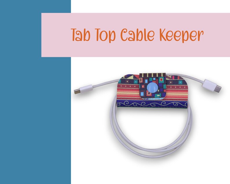 May include: A colorful cable keeper with a geometric pattern and a blue button. The keeper is attached to a white cable.