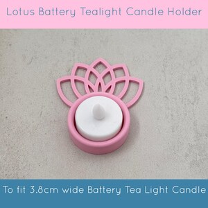 May include: A pink lotus-shaped battery tealight candle holder. The holder is designed to fit a 3.8cm wide battery tea light candle. The text "Lotus Battery Tealight Candle Holder" is at the top, and "To fit 3.8cm wide Battery Tea Light Candle" is at the bottom.