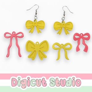 May include: A collection of yellow and pink bow-shaped earrings and charms. Two yellow bow earrings hang from silver hooks. The other bows are flat, with a hole for stringing. The text "Digicut Studio" is at the bottom.
