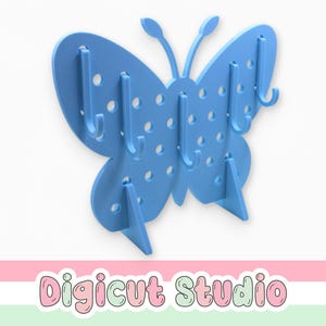 May include: A light blue butterfly-shaped wall organizer with multiple hooks for hanging items. The organizer has a series of small holes and is supported by two angled feet. The text "Digicut Studio" is at the bottom.