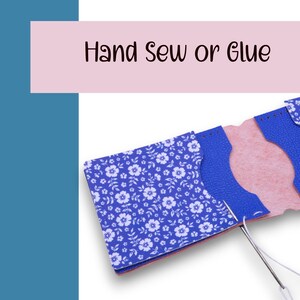 May include: A partially constructed blue floral patterned wallet with a pink interior. The text "Hand Sew or Glue" is displayed above the wallet. A needle and thread are in the process of sewing the wallet together.