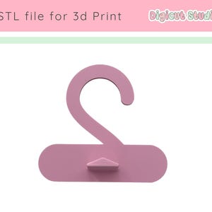 May include: A light pink 3D-printed hanger with a curved hook and a rectangular base. The text "STL file for 3d Print" is at the top left, and "Digicut Studio" is at the top right.