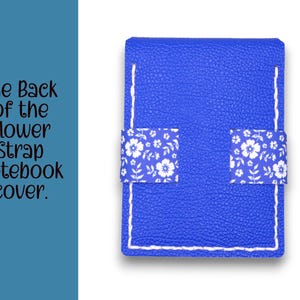 May include: A blue notebook cover with white stitching and two floral patterned straps. The text on the left says, "The Back of the Flower Strap notebook cover."