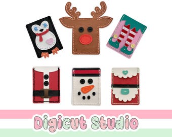 Puede incluir: Seis tarjeteros rectangulares con motivos navideños que presentan diseños cosidos de un pingüino, un reno marrón, piernas de elfo, un traje de Santa Claus, un muñeco de nieve con nariz naranja y un conjunto rojo y blanco con corazones.