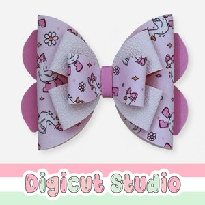 May include: A large, layered hair bow with a light pink background and a pattern of white geese wearing boots, flowers, and bows. The bow has white and pink layers, with solid pink accents on the sides and center. The text "Digicut Studio" is at the bottom.