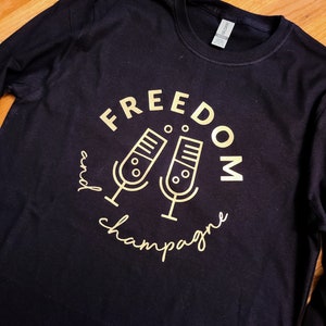 Freedom and Champagne Podcast unisex shirt. Long sleeved, COTTON soft feel, black shirt w/ gold logo. Supports black women owned companies. image 1