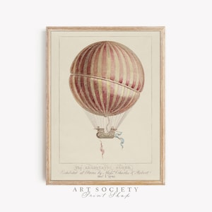 May include: A framed vintage print depicting a hot air balloon with red and gold stripes. The balloon is suspended from a basket with ribbons. The print includes the text "The AEROSTATIC GLOBE" and "ART SOCIETY Print Shop."