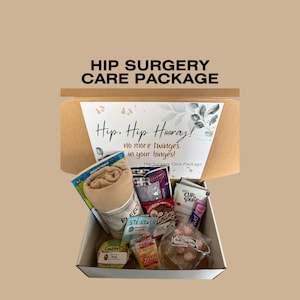 May include: A hip surgery care package in a white box with various items. The box includes a fleece blanket, snacks, and a card that reads "Hip, Hip Hooray! no more twinges in your hinges!" The package is designed to provide comfort and support.