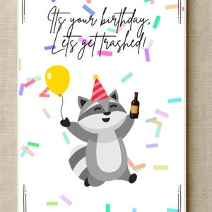 May include: Birthday card with a cartoon raccoon wearing a party hat, holding a bottle and a yellow balloon. The card has the text "It's your birthday. Let's get trashed!" with confetti.