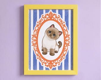May include: A framed print featuring a light brown and white kitten with blue eyes, centered within an ornate orange oval frame. The background consists of vertical blue and white stripes, all enclosed in a bright yellow rectangular frame.