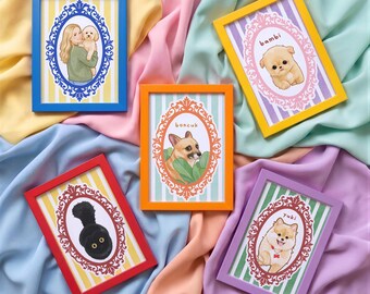 May include: Five rectangular picture frames in blue, yellow, orange, red, and purple, each containing a portrait illustration. The prints feature a person with a dog, and individual dogs labeled with the names bambi, boncuk, and yuki.