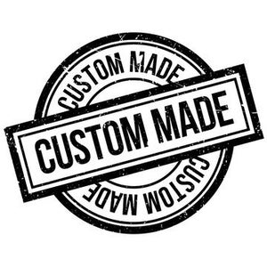 May include: A black and white distressed rubber stamp with the text "CUSTOM MADE" in a rectangular shape and a circular shape.