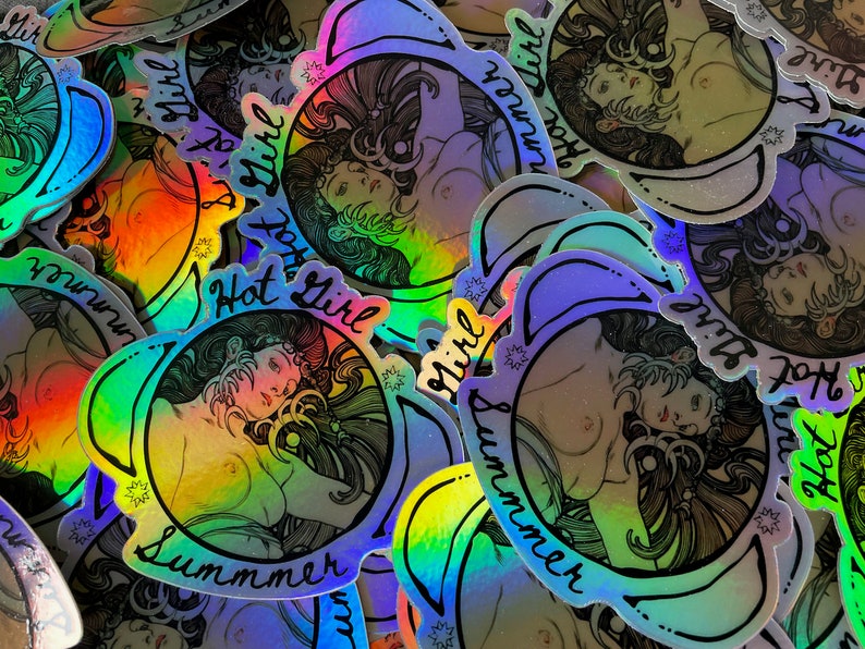 May include: Holographic stickers featuring a stylized illustration of a woman with long hair, a floral design, and the text "Hot Girl Summer." The stickers have a rainbow sheen and a black outline.
