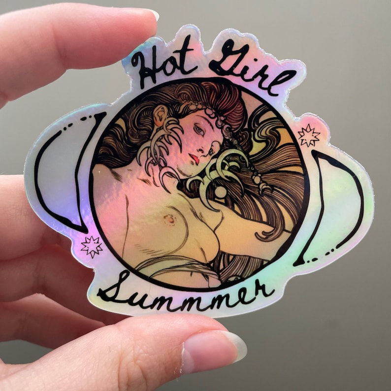 May include: Holographic sticker featuring a nude illustration of a woman with long hair, framed by a decorative border. The sticker has the words "Hot Girl Summer" in a handwritten font.