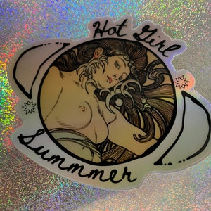 May include: Holographic sticker featuring a nude illustration of a woman with long hair, framed by crescent moons and stars. The words "Hot Girl Summer" are written in black script around the image. The sticker has a shiny, iridescent finish.