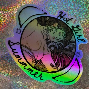 May include: Holographic sticker featuring a detailed illustration of a woman with long hair, with the words "Hot Girl Summer" in black script. The sticker has a rainbow gradient effect.