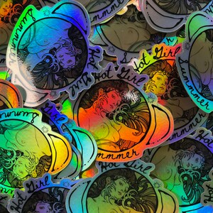 May include: A collection of holographic stickers featuring a woman's portrait with long hair, encircled by the words "Summer Hot Girl." The stickers have a rainbow sheen and a vintage aesthetic.