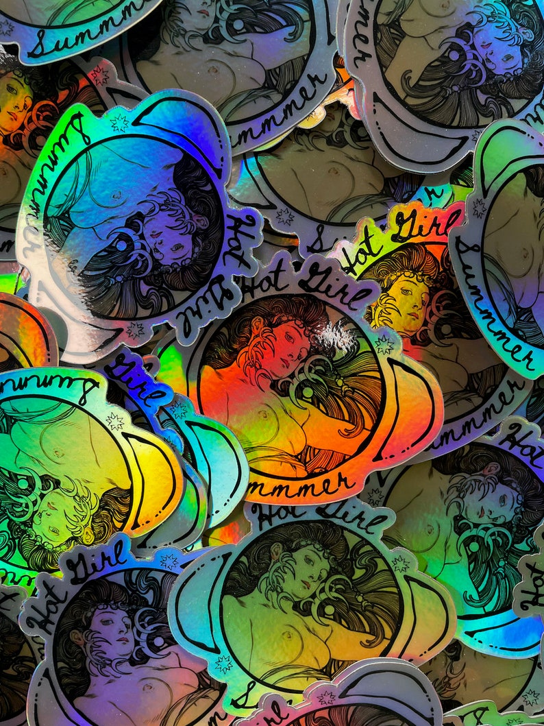 May include: A collection of holographic stickers featuring a woman's portrait with long hair, encircled by the words "Summer Hot Girl." The stickers have a rainbow sheen and a vintage aesthetic.