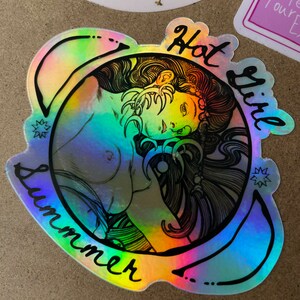 May include: Holographic sticker with a black outline of a woman's portrait, encircled by the words "Hot Girl Summer." The sticker has a rainbow sheen, with colors shifting from blue to green and yellow. The design includes star accents.