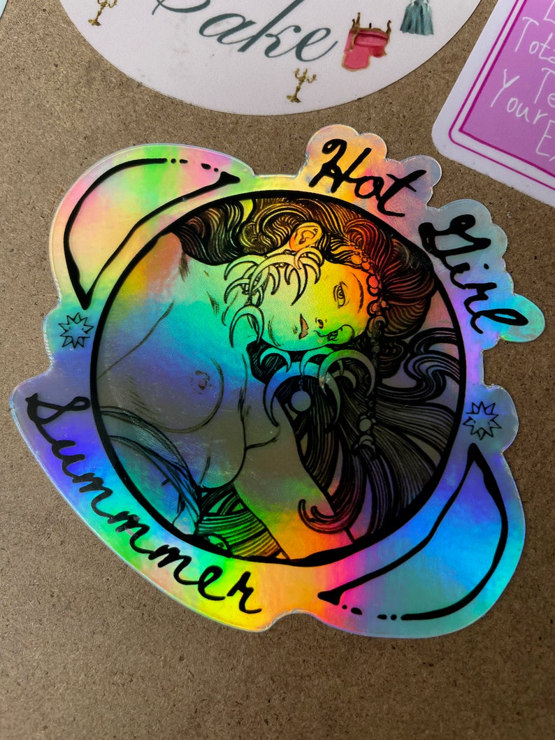 May include: Holographic sticker with a black outline of a woman's portrait, encircled by the words "Hot Girl Summer." The sticker has a rainbow sheen, with colors shifting from blue to green and yellow. The design includes star accents.