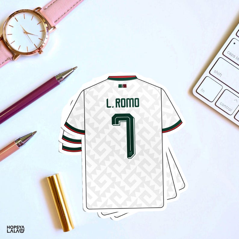 May include: A white soccer jersey sticker featuring a repeating light gray geometric pattern, the name L. ROMO, and the number 7 in dark green. The jersey has dark green and red trim on the sleeves and collar, with a small Mexican flag icon.