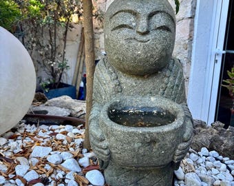 Monk statue with stone cup