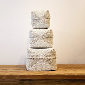 Beige and white decorative box made of bamboo and pearls