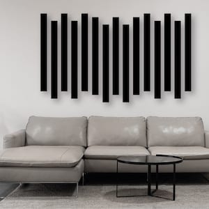 May include: A gray sectional sofa with a black coffee table in front of it. A black geometric wall art piece is hanging on the wall behind the sofa.