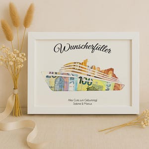 May include: White frame with a black and white image of a cruise ship made of euro bills. The text "Wunschersch&uuml;ller" is at the top of the frame. The text "Alles Gute zum Geburtstag Sabine & Marcus" is at the bottom of the frame.