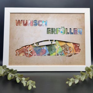 May include: A white rectangular frame containing a tan background with the cut-out text WUNSCH ERF&Uuml;LLER and a sports car silhouette. The cut-out areas reveal a collage of colorful Euro banknotes in various denominations behind the tan surface.