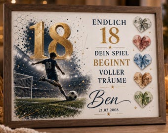 May include: A framed print featuring a football player kicking a ball in a stadium, the number 18 in gold, and the text ENDLICH 18 DEIN SPIEL BEGINNT VOLLER TRÄUME Ben 21.03.2008. Five heart-shaped folded banknotes are arranged vertically on the right side.