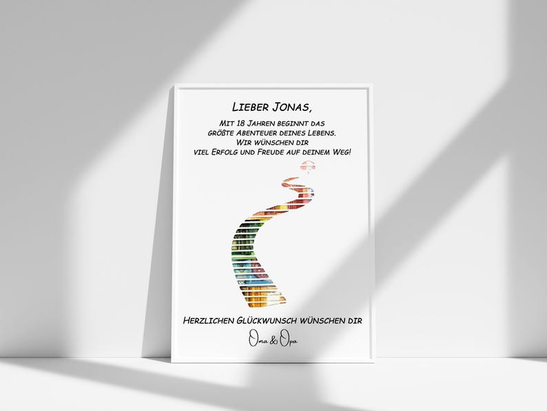May include: A white framed print with a colorful road design and the text "Lieber Jonas, Mit 18 Jahren beginnt das gr&ouml;&szlig;te Abenteuer deines Lebens. Wir w&uuml;nschen dir viel Erfolg und Freude auf deinem Weg! Herzlichen Gl&uuml;ckwunsch w&uuml;nschen dir Oma & Opa".