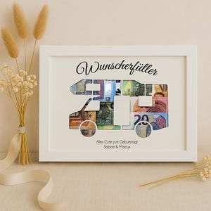 May include: White framed picture with a camper van cutout filled with euro bills. The text "Wunschersch&uuml;ller" is at the top of the frame and "Alles Gute zum Geburtstag Sabine & Marcus" is at the bottom.