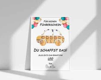 May include: A white card with a colorful car made of money, balloons, and the text "FÜR DEINEN FÜHRERSCHEIN DU SCHAFFST DAS! ALLES GUTE ZUM GEBURTSTAG LEO Von Oma & Opa"