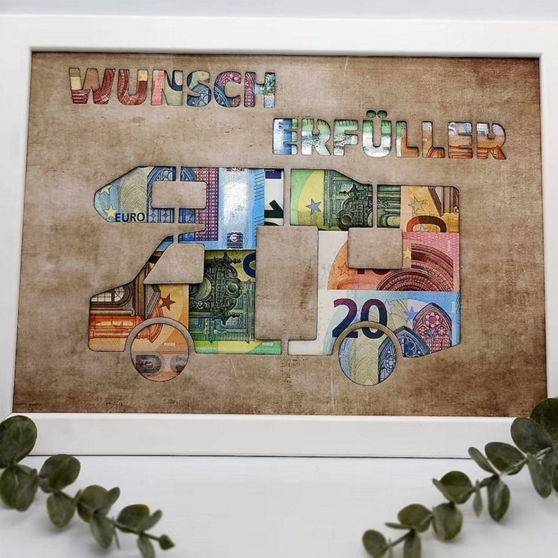 May include: A framed artwork featuring a camper van silhouette made of euro banknotes. The words "Wunsch Erf&uuml;ller" are displayed above the camper van.