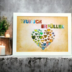 Puede incluir: Una impresi&oacute;n enmarcada con fondo blanco y un coraz&oacute;n hecho de corazones de papel de colores. El texto "Wunsch Erf&uuml;ller" est&aacute; impreso en letras de colores en la parte superior de la impresi&oacute;n.