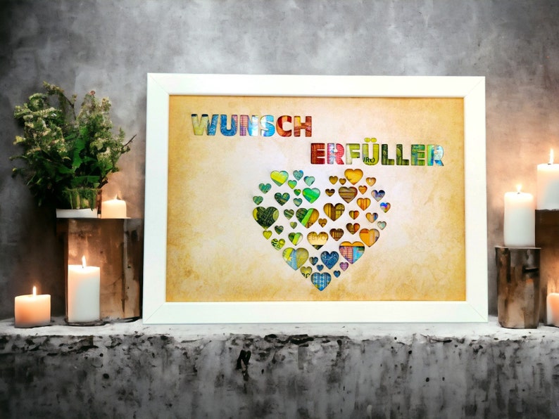 Puede incluir: Una impresi&oacute;n enmarcada con fondo blanco y un coraz&oacute;n hecho de corazones de papel de colores. El texto "Wunsch Erf&uuml;ller" est&aacute; impreso en letras de colores en la parte superior de la impresi&oacute;n.