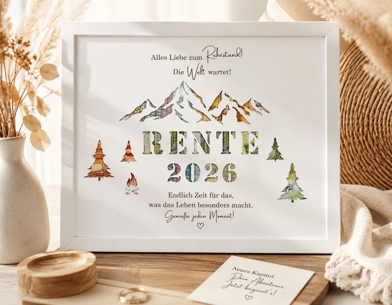 May include: A white framed print featuring a mountain range graphic with plaid patterns, the text RENTE 2026, and German phrases including Alles Liebe zum Ruhestand, Die Welt wartet, Endlich Zeit f&uuml;r das, was das Leben besonders macht, and Genie&szlig;e jeden Moment.