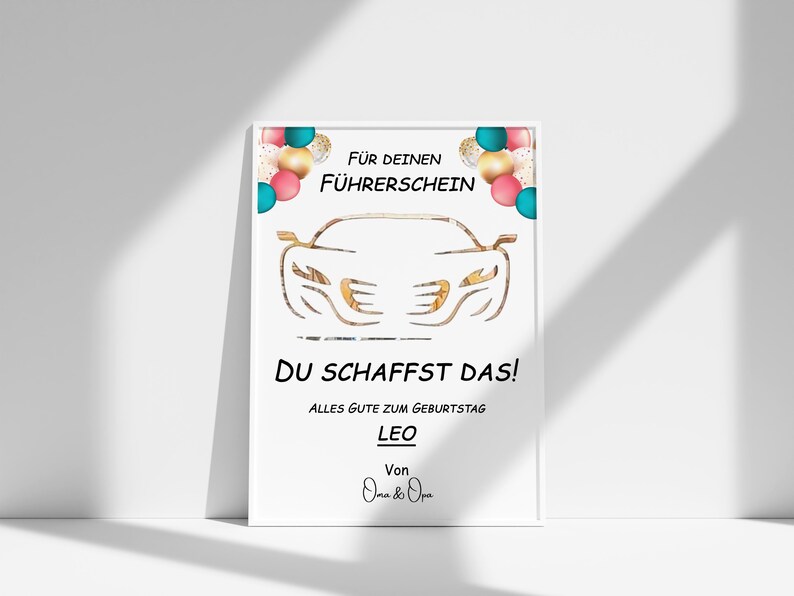 May include: A white card with a gold car outline and colourful balloons. The text reads "For your driving licence, you got this! All the best for your birthday, Leo. From Oma & Opa."