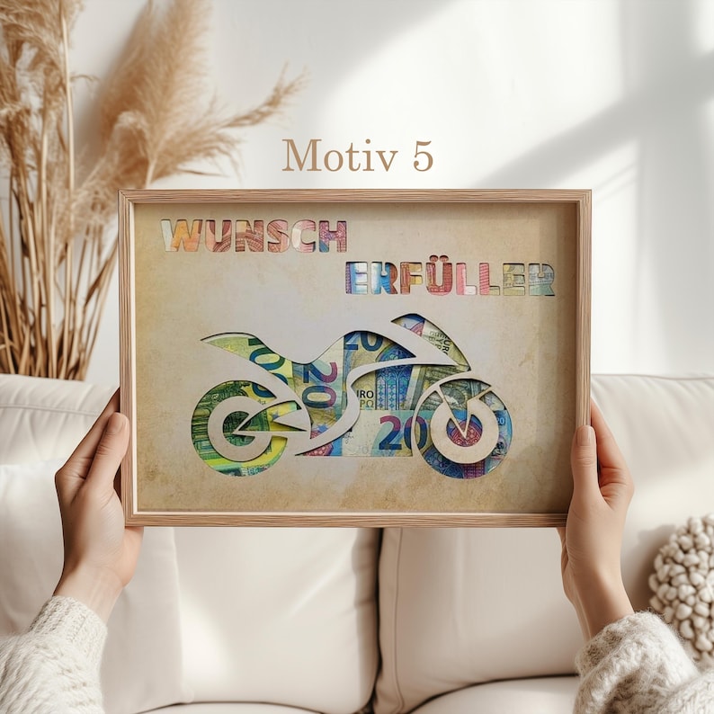 May include: A framed print with a motorcycle silhouette made of euro bills. The text "Wunsch Erf&uuml;ller" is printed above the motorcycle.