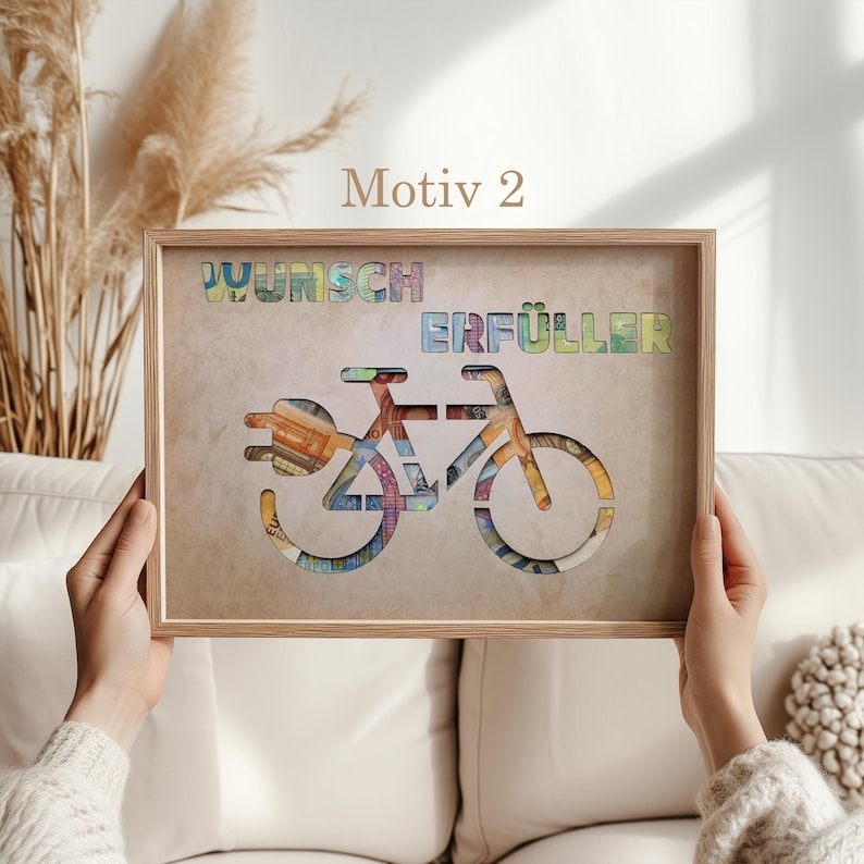 May include: A framed print with a bicycle made of money. The words "Wunsch Erf&uuml;ller" are written above the bicycle.