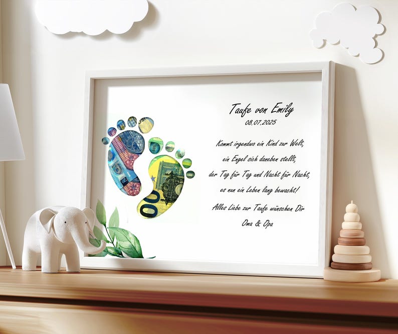May include: A white framed print with a poem about a baby's arrival. The poem is written in German. The print features two baby footprints made of money. The footprints are surrounded by green leaves. The print is titled "Taufe von Emily" and the date "08.07.2025" is printed below the title.
